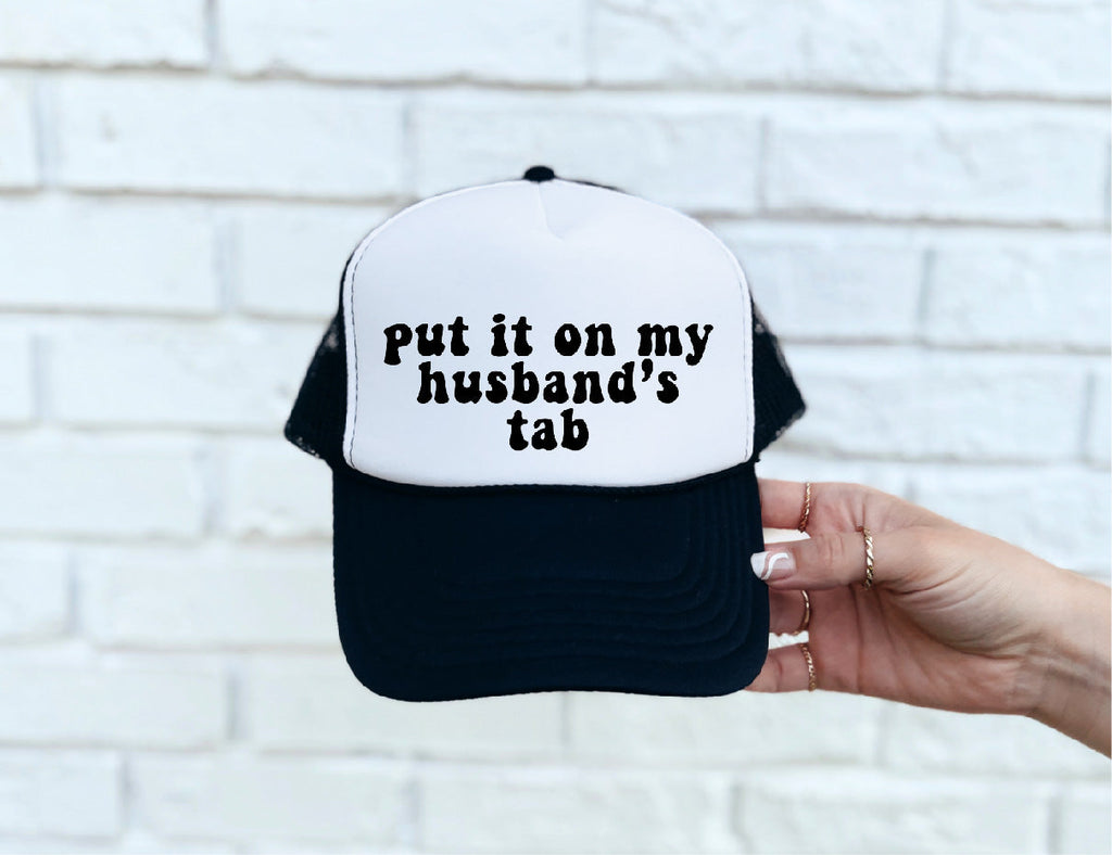 Put It On My Husband's Tab Black & White Trucker Hat